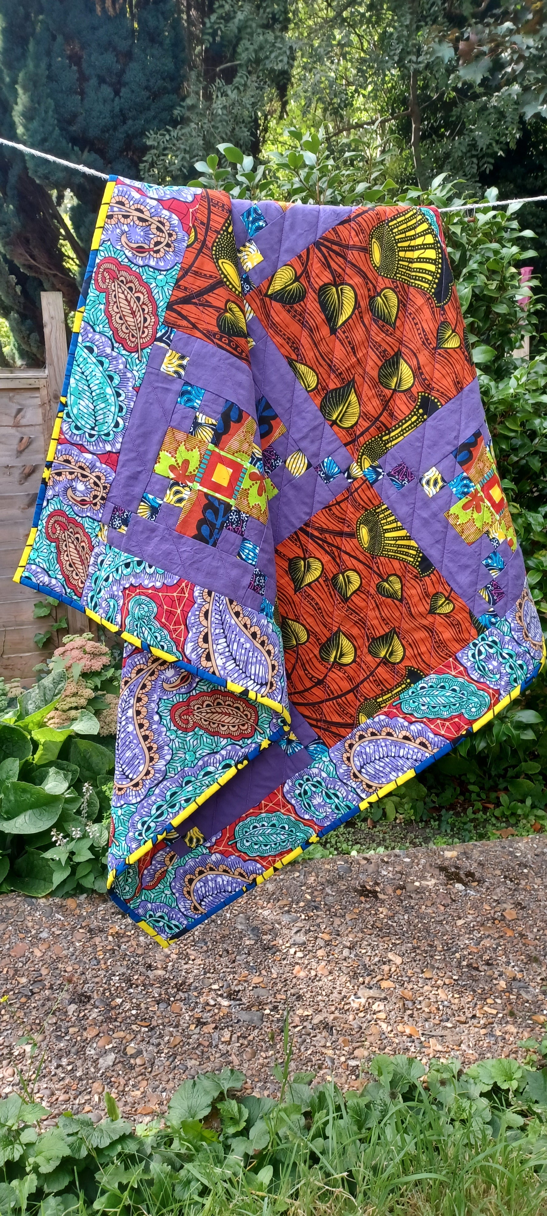patchwork square baby quilt made from african wax fabrics